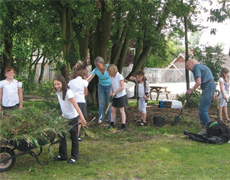 Christine Maclaren and Jack Stuart with some of the after school club, clearing the copse area.