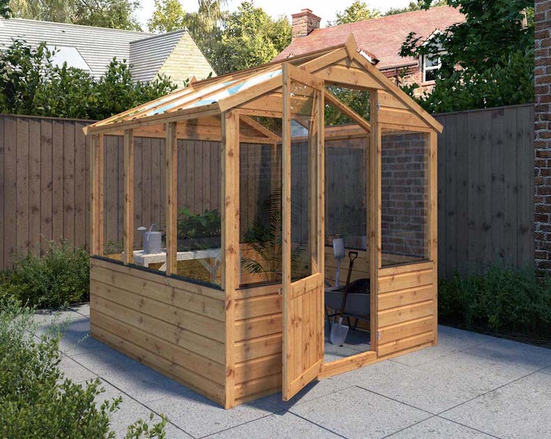 Large wooden greenhouse with doors open