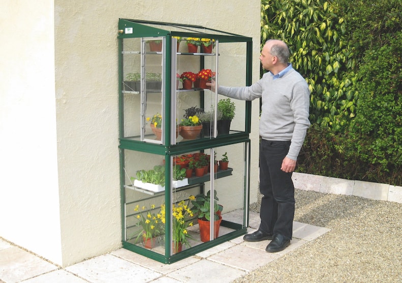 Green metal lean-to greenhouse