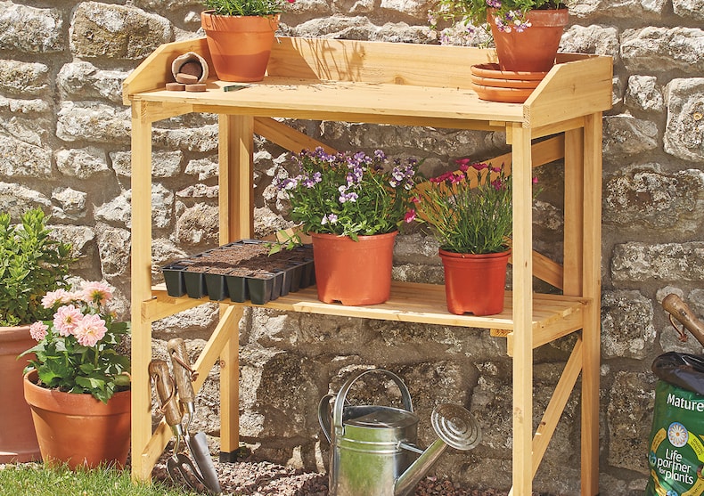 Wooden potting table against wall