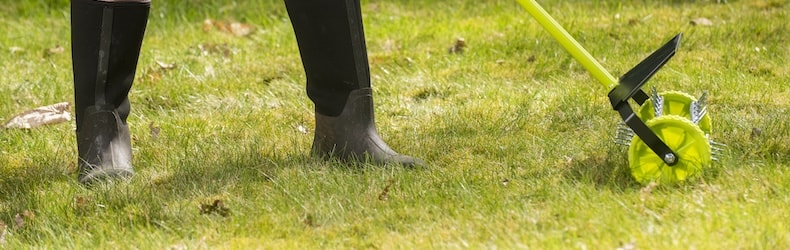 Man aerating lawn