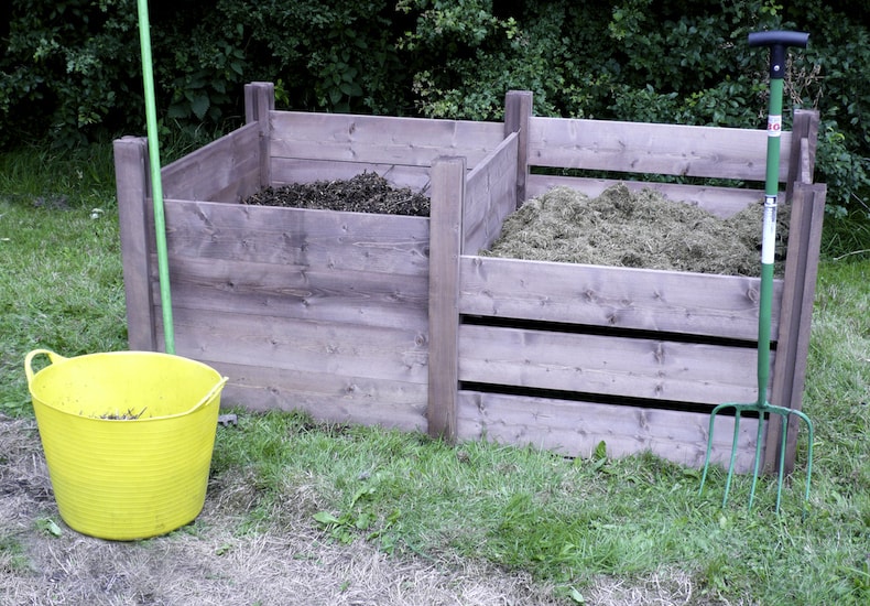TWo modular compost bins next to yellow bucket