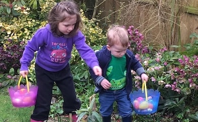 Children hunting eggs in garden