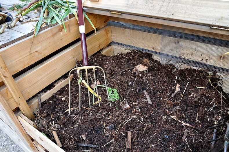 gardening fork in compost patch